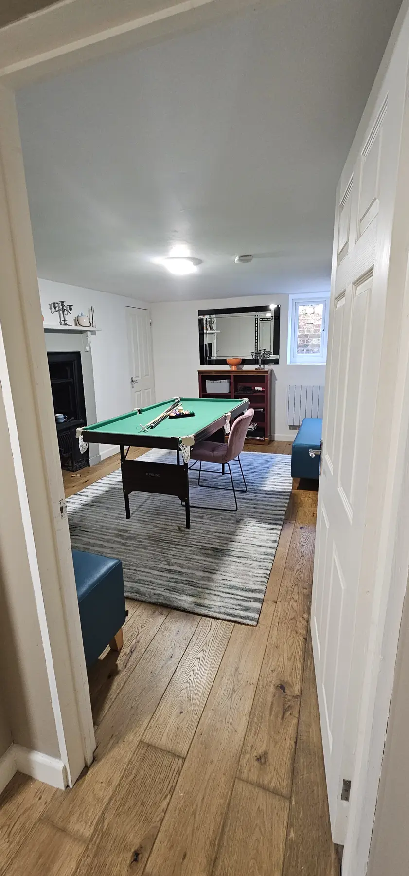 Games room with original fireplace, a lightwell window and oak floor