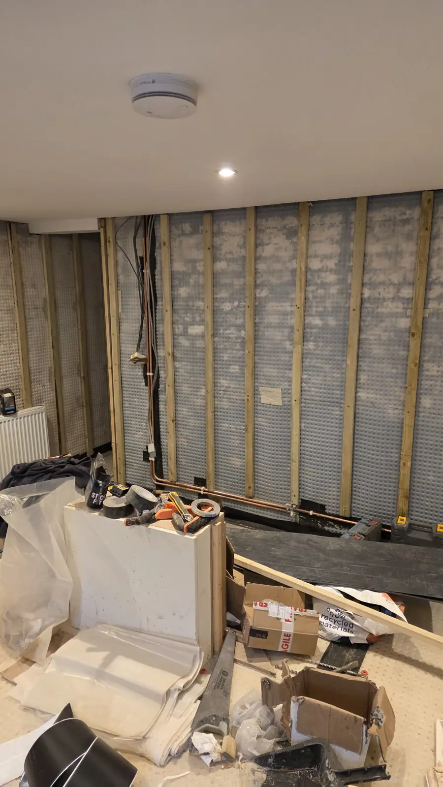 Walls stripped back and new cavity drain membrane fixed, with pipework re-run