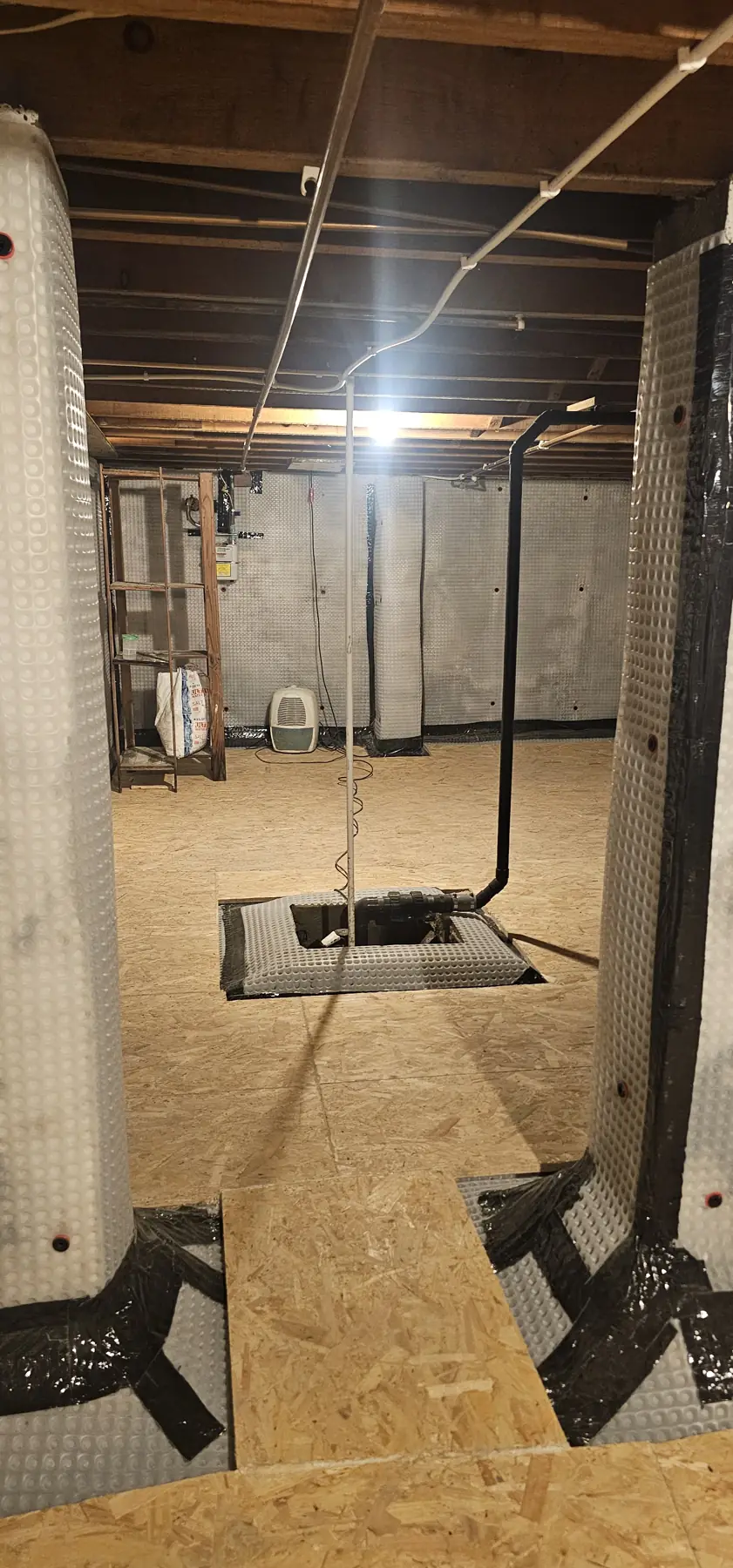 Large basement under a Faversham flat with cavity drain membrane on every wall, a new sump and a boarded floor