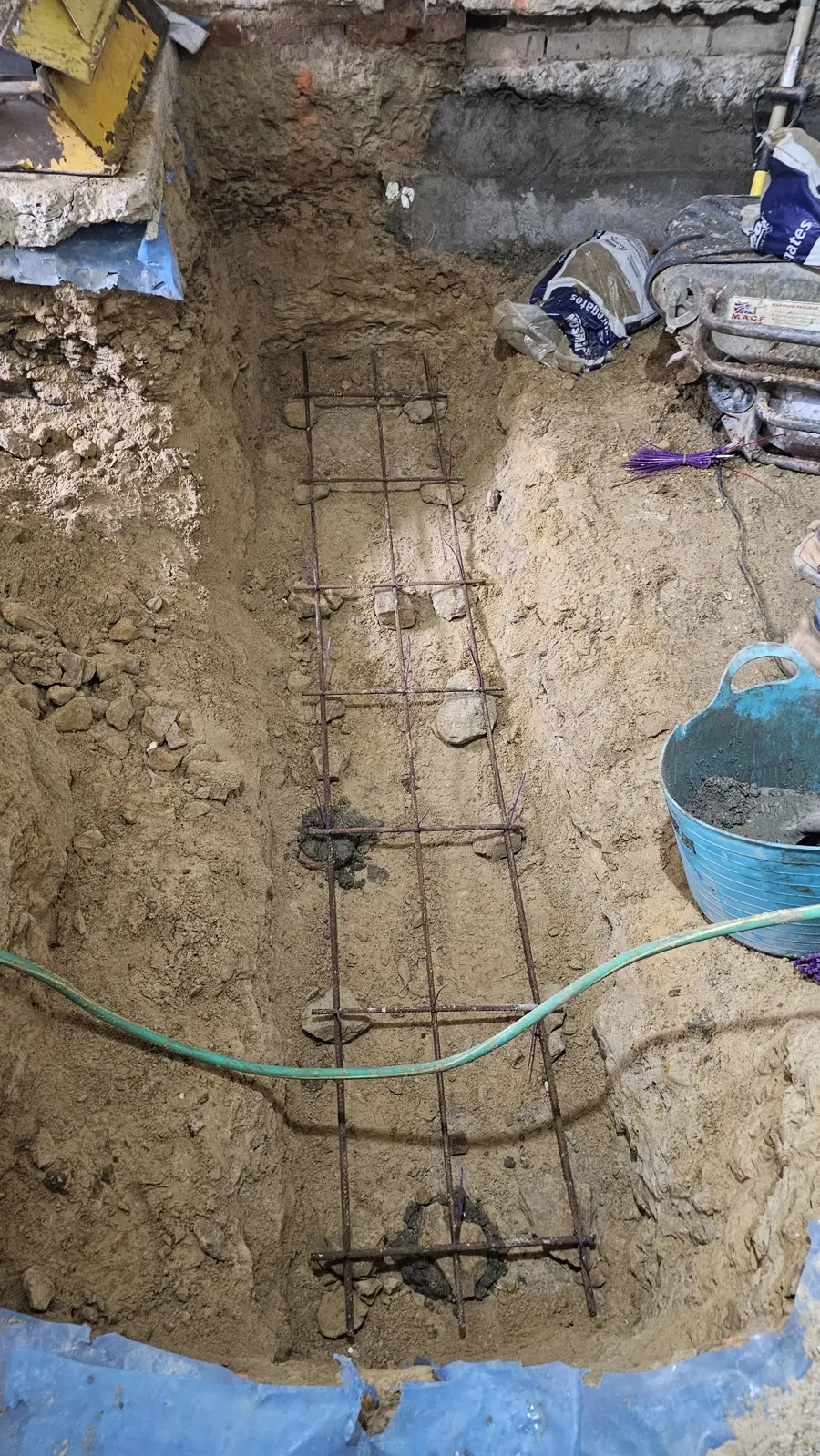 Steel reinforcement cage in an underpinning trench before the concrete pour