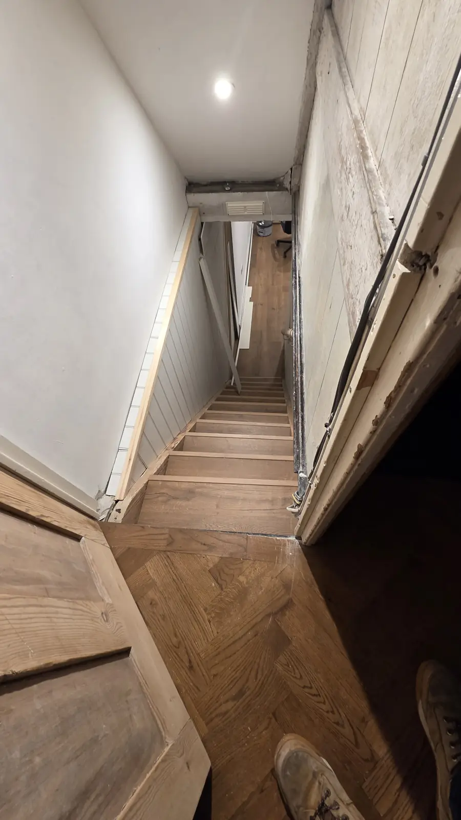 New oak-effect staircase down to the finished basement bedroom